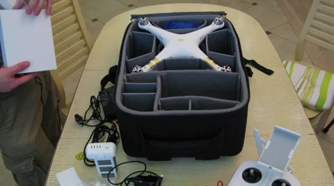 Man assembles DJI Phantom quadrocopter on table. Timelapse Stock Footage 65182023