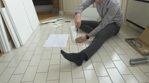 Man assembles drawer of flat pack furniture -time lapse Stock Footage 56071108