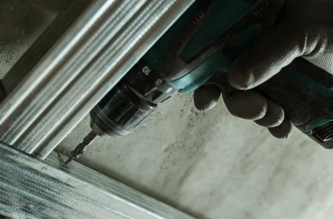 Man assembles profile metal frame Stock Photos