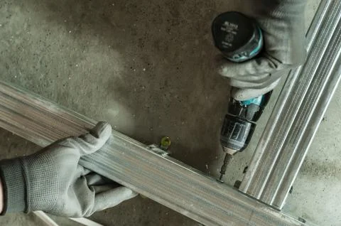 Man assembles profile metal frame Stock Photos