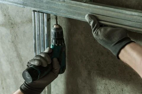 Man assembles profile metal frame Stock Photos