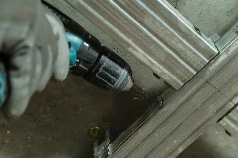 Man assembles profile metal frame Stock Photos