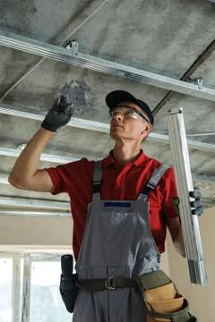 Man assembles profile metal frame Stock Photos