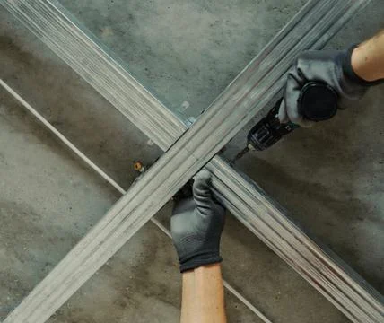 Man assembles profile metal frame Stock Photos