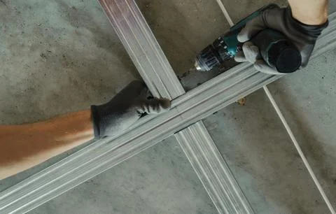 Man assembles profile metal frame Stock Photos