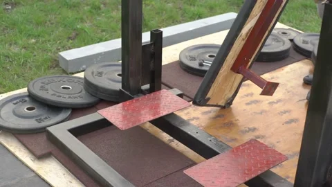 A man assembles a simulator in his garden Stock Footage 131059989