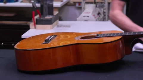 Man assembling acoustic guitar. Fast motion. Stock Footage 141257298
