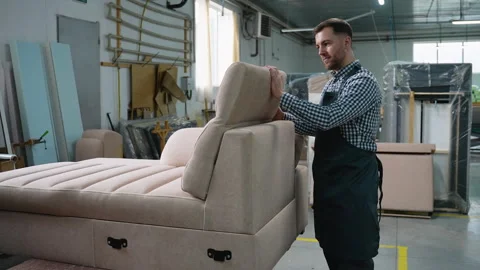 Man Assembling Adjustable Sofa Backrest in Workshop Stock-Footage 305611061