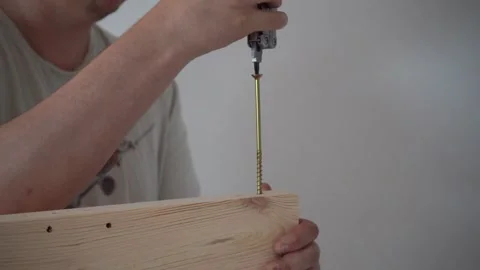 Man Assembling Bed, Screwing Bolt into Bed Frame, DIY Furniture Assembly Stock Footage 316706500