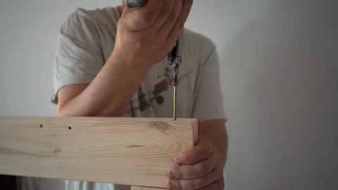Man Assembling Bed, Screwing Bolt into Bed Frame, DIY Furniture Assembly Stock Footage 316706508