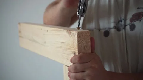 Man Assembling Bed, Screwing Bolt into Bed Frame, DIY Furniture Assembly Stock Footage 316706550