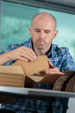 A man is assembling carton Stock Photos