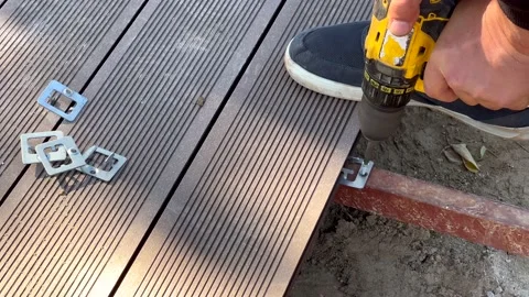 Man assembling composite deck using cordless screwdriver. Stock Footage 166173783