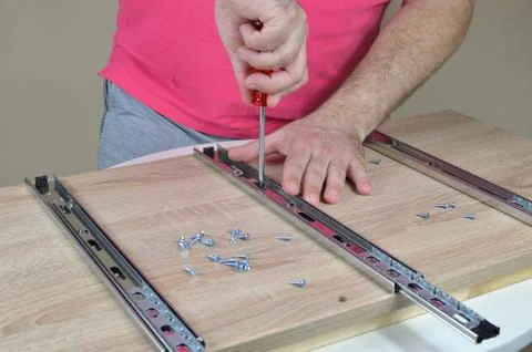 Man assembling elements of a furniture Stock Photos