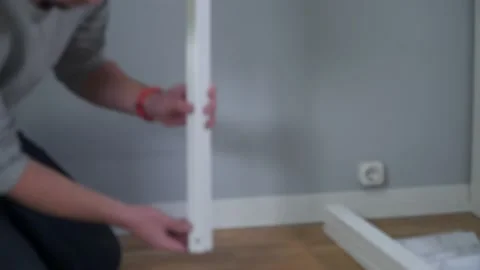 Man assembling flat pack furniture DIY at home on floor. Man bought furniture Stock Footage 150771356