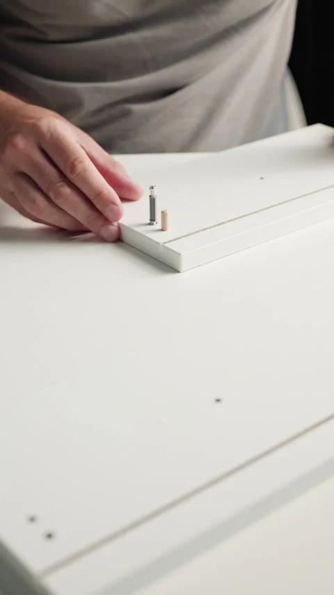 Man Assembling Flat Pack Furniture at Home Video stock 344143845