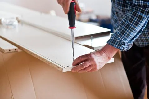 Man Assembling Flat Pack Furniture Stock Photos