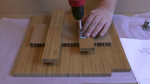 Man assembling furniture using electric screwdriver  Stock Footage 85266149