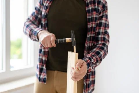 Man Is Assembling Furniture Using Hammer Stock Photos