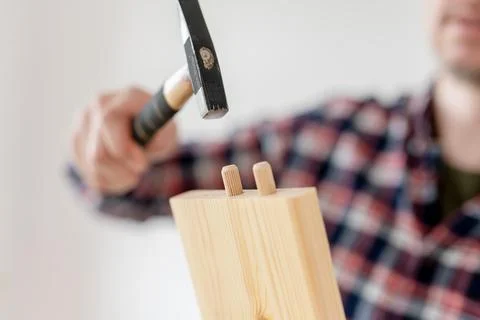 Man Is Assembling Furniture Using Hammer Stock Photos
