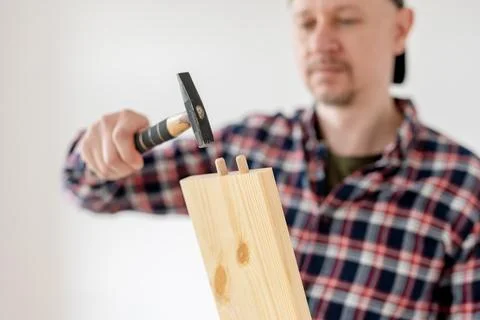 Man Is Assembling Furniture Using Hammer Stock Photos