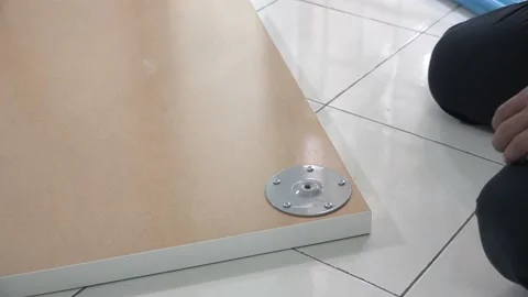 A man assembling IKEA table top Stock Footage 145704058