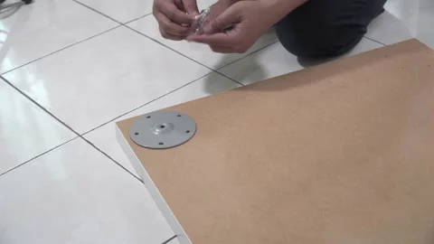 A man assembling IKEA table top Stock Footage 145704085