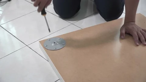 A man assembling IKEA table top Stock Footage 145704104