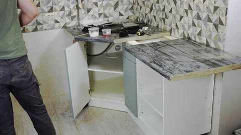 A man assembling kitchen furniture, timelapse. Stock Footage 201179836