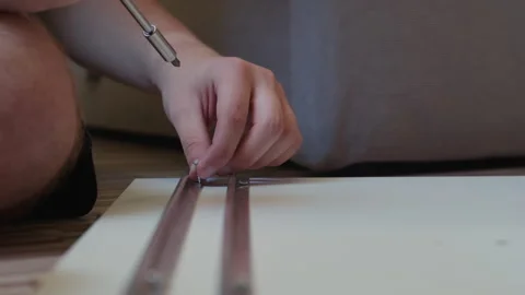 Man Assembling New Wardrobe With Hardware Parts Video stock 338375469
