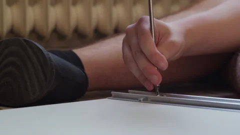 Man Assembling New Wardrobe With Screwdriver Vídeo Stock 338375486