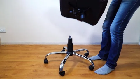 Man assembling office chair at home Stock Footage 99011162