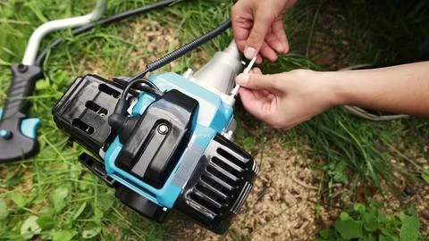 A man assembling parts of the string trimmer. Stock Photos