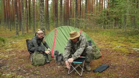 The man is assembling a portable camping table. Stockbeeldmateriaal 320766701