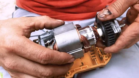 Man assembling power tool known as electric drill machine, that forms his Stock Footage 171442276