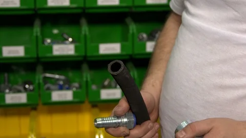 Man assembling rubber hose close up video Stock Footage 119230358