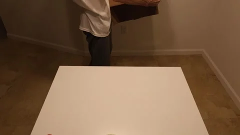 Man assembling, sealing cardboard box with tape and attaching postal label Stock Footage 327067302