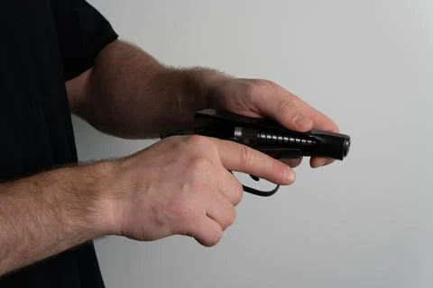 Man assembling semi automatic pistol by mounting slide onto frame Stock Photos
