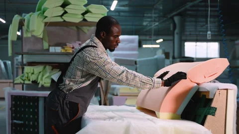 Man Assembling Upholstery Foam on Sofa Backrest Stock Footage 305610063