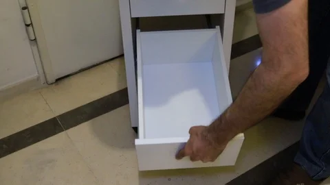 A man assembling white furniture Video stock 116725542