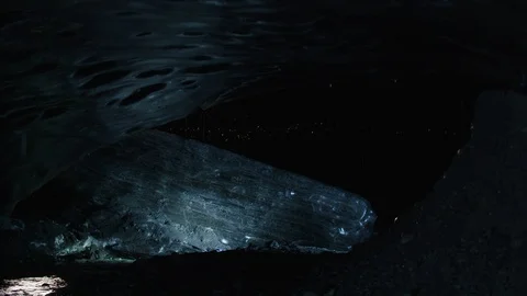 Man in astronaut suit exploring an ice cave, Iceland Stock Footage 104237221