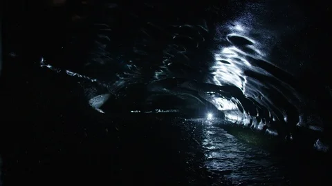 Man in astronaut suit exploring an ice cave, Iceland Video stock 104238129