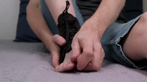 Man athlete after an ankle joint injury in a special compression fixing bandage. Stock Footage 195308331