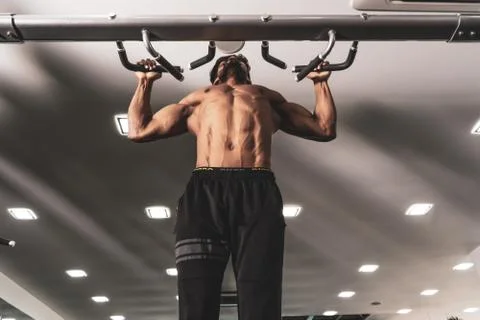 Man Athlete Doing Pull Ups - Chin-Ups In The Gym Stock Photos