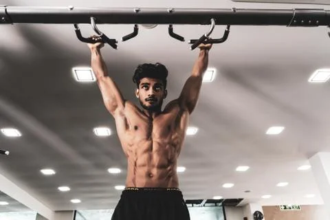 Man Athlete Doing Pull Ups - Chin-Ups In The Gym Stock Photos