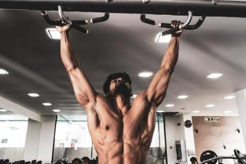 Man Athlete Doing Pull Ups - Chin-Ups In The Gym 库存照片
