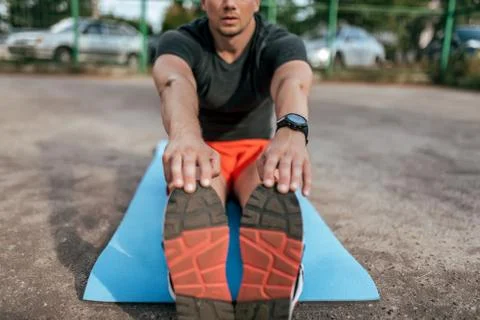 A man athlete doing workout on mat, gymnastics, training, fitness workout Stock Photos