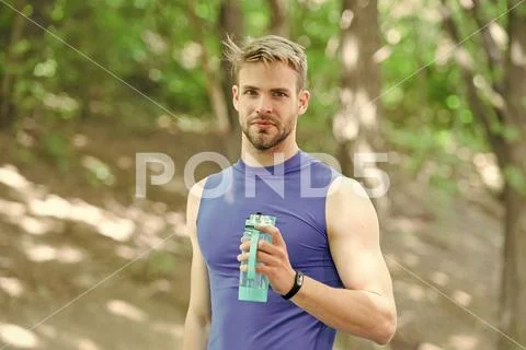 Man athlete hold bottle care hydration body after workout. Refreshing vitamin Stock Photos