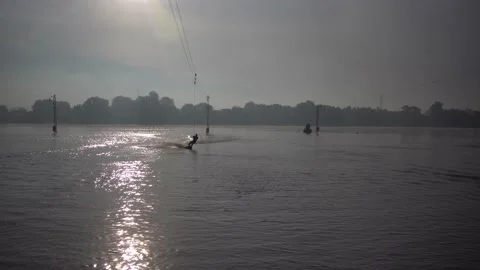 Man, athlete. rides a wakeboard. jumping from a springboard in the water. Stock Footage 142813193