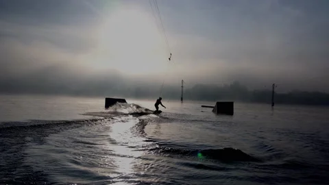 Man, athlete. rides a wakeboard. jumping from a springboard in the water. Stock Footage 142824952